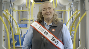 Pageant winner Krista Stone on board a TriMet MAX Train wearing her pageant sash
